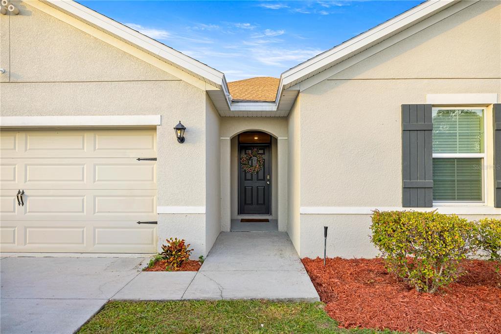 3833 Southeast 98th Place Belleview, FL 34420 - Photo 10 of 34 a front view of a house with garden