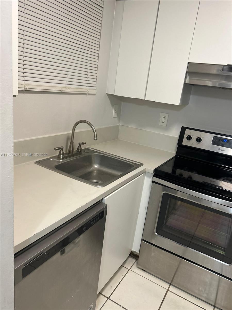 14930 Southwest 82nd Terrace, Unit 16304 Miami, FL 33193 - Photo 15 of 16 a kitchen with a sink appliances and cabinets