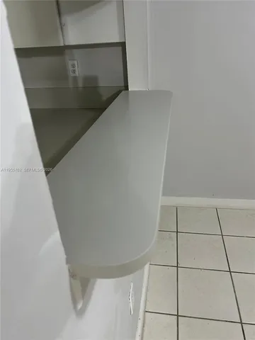 a view of a small space with wooden floor and a window