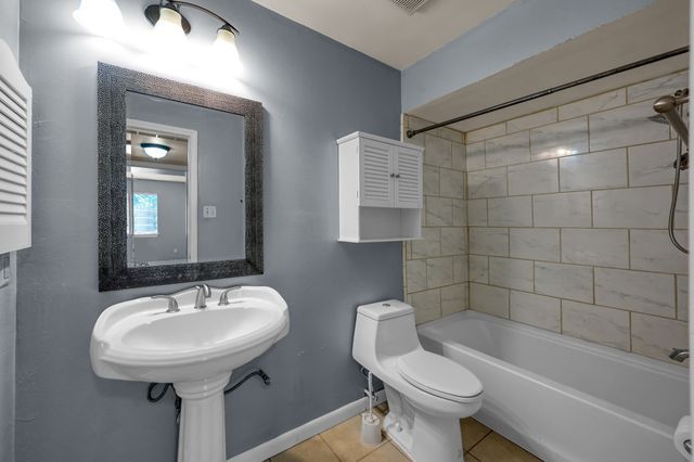 a bathroom with a sink a toilet and bathtub