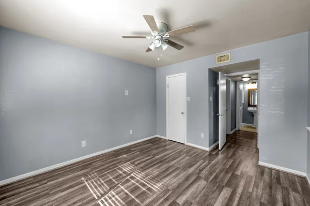 a view of a room with wooden floor