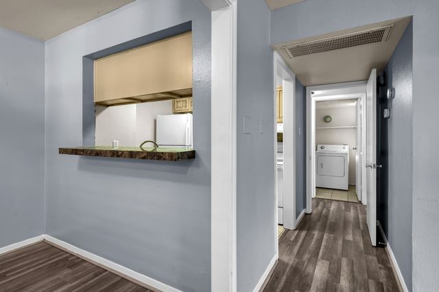 a view of an entryway with wooden floor