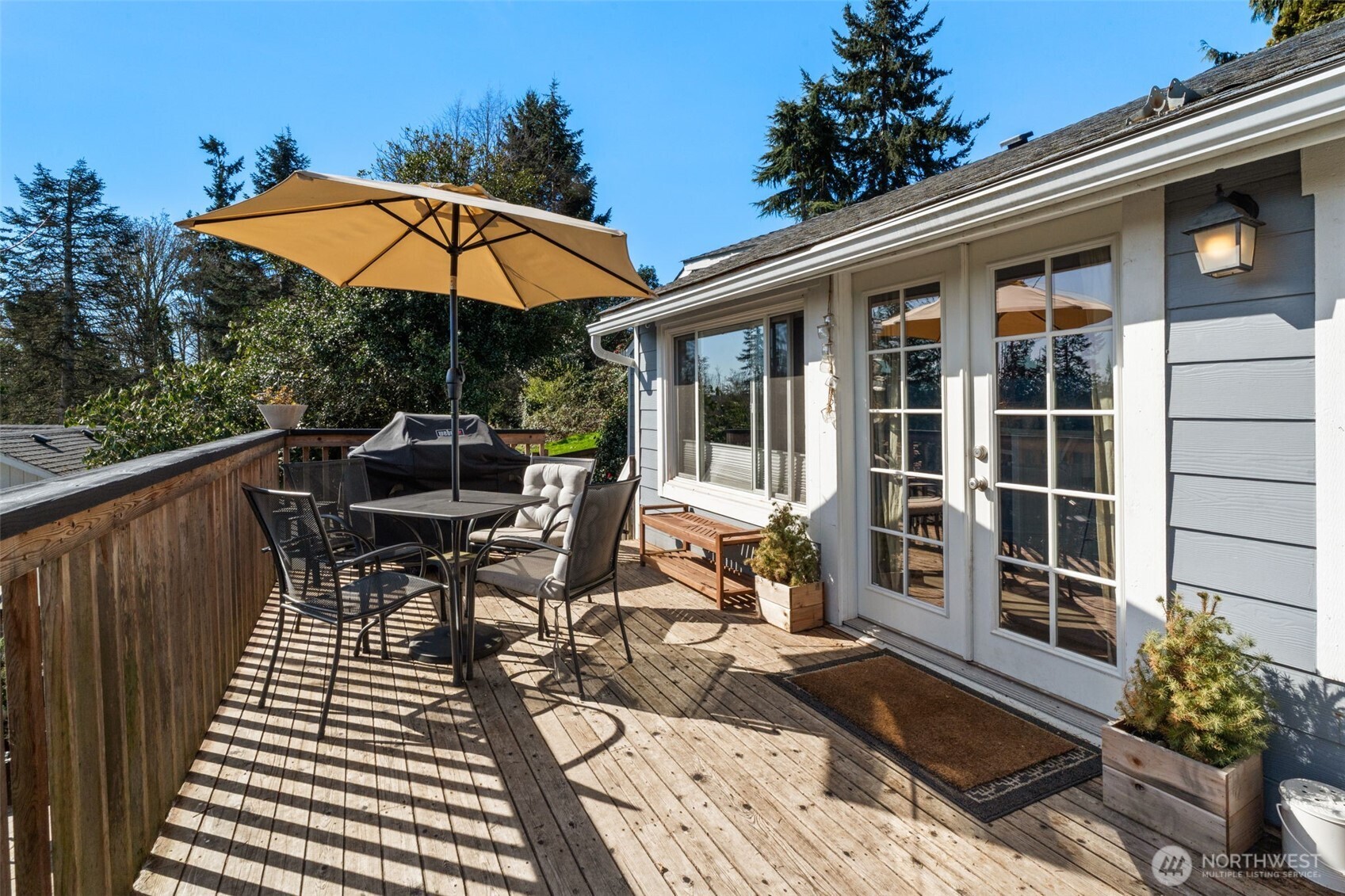 2827 Alder Street Bremerton, WA 98310 - Photo 24 of 35 a view of a patio with table and chairs under an umbrella with wooden floor
