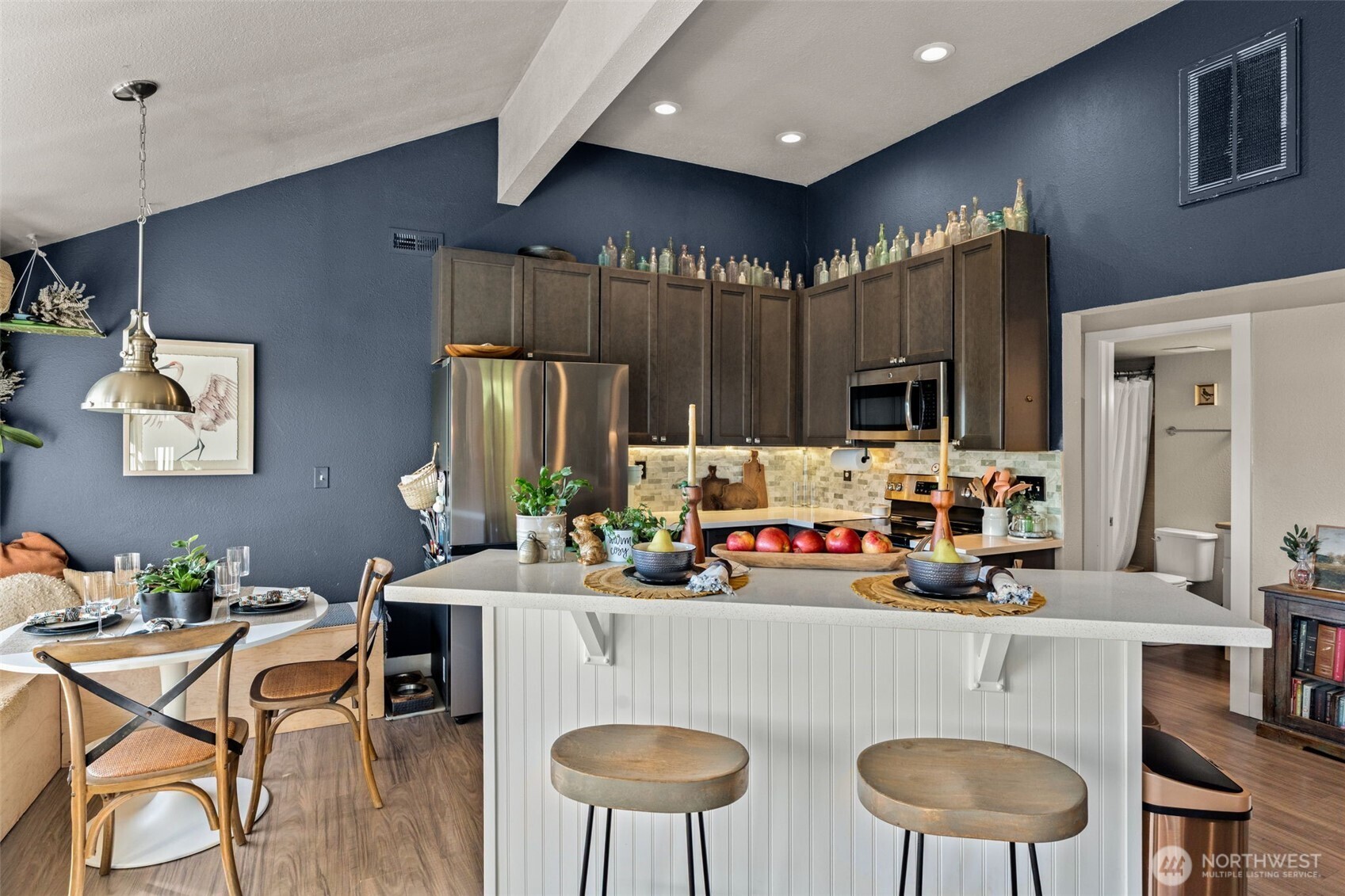 2827 Alder Street Bremerton, WA 98310 - Photo 9 of 35 a kitchen with stainless steel appliances a dining table chairs sink and white cabinets