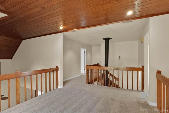 a view of a hallway with stairs
