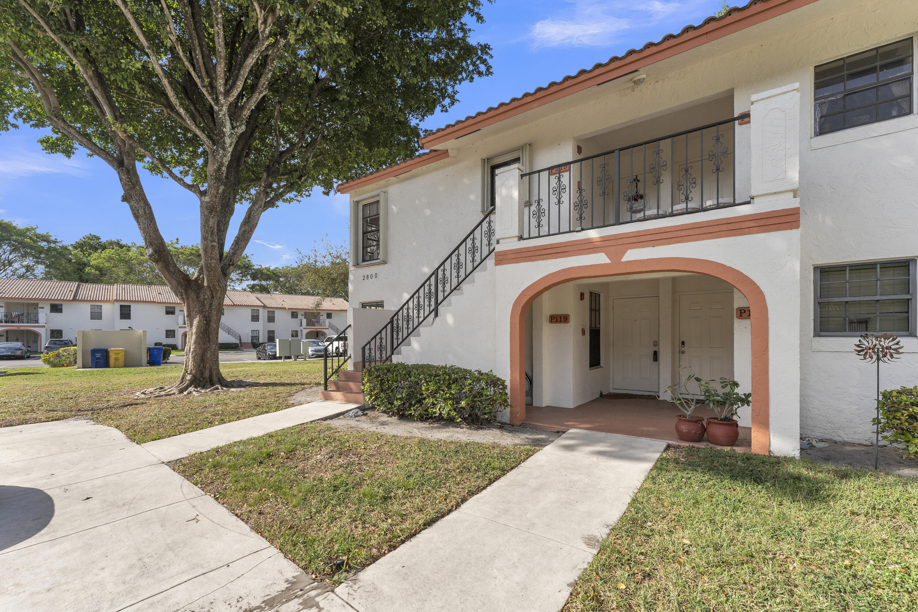 2800 Palmwood Terrace, Unit 2190 Boca Raton, FL 33431 - Photo 1 of 42 a front view of a house with a yard