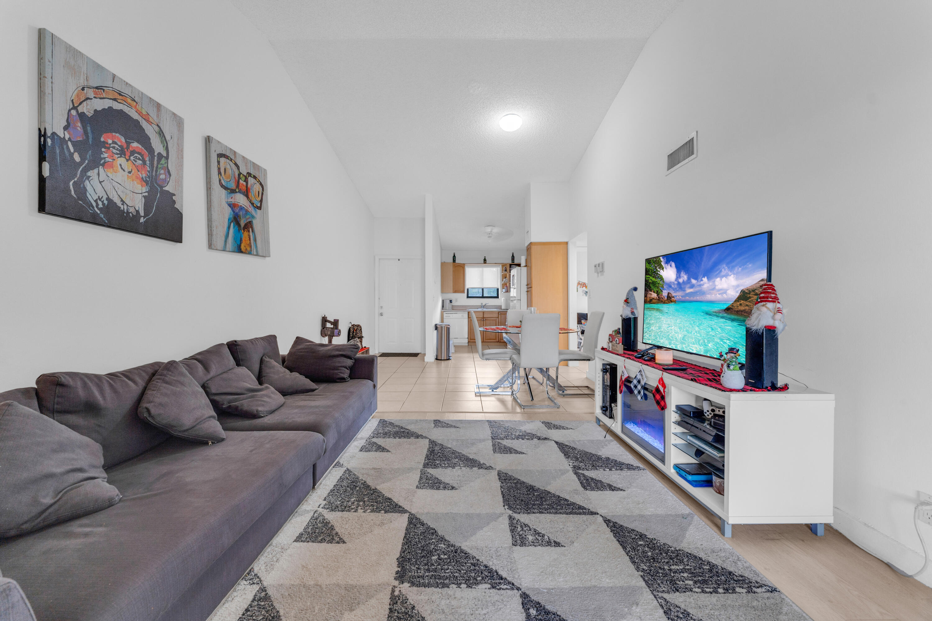 2800 Palmwood Terrace, Unit 2190 Boca Raton, FL 33431 - Photo 15 of 42 a living room with furniture and a flat screen tv