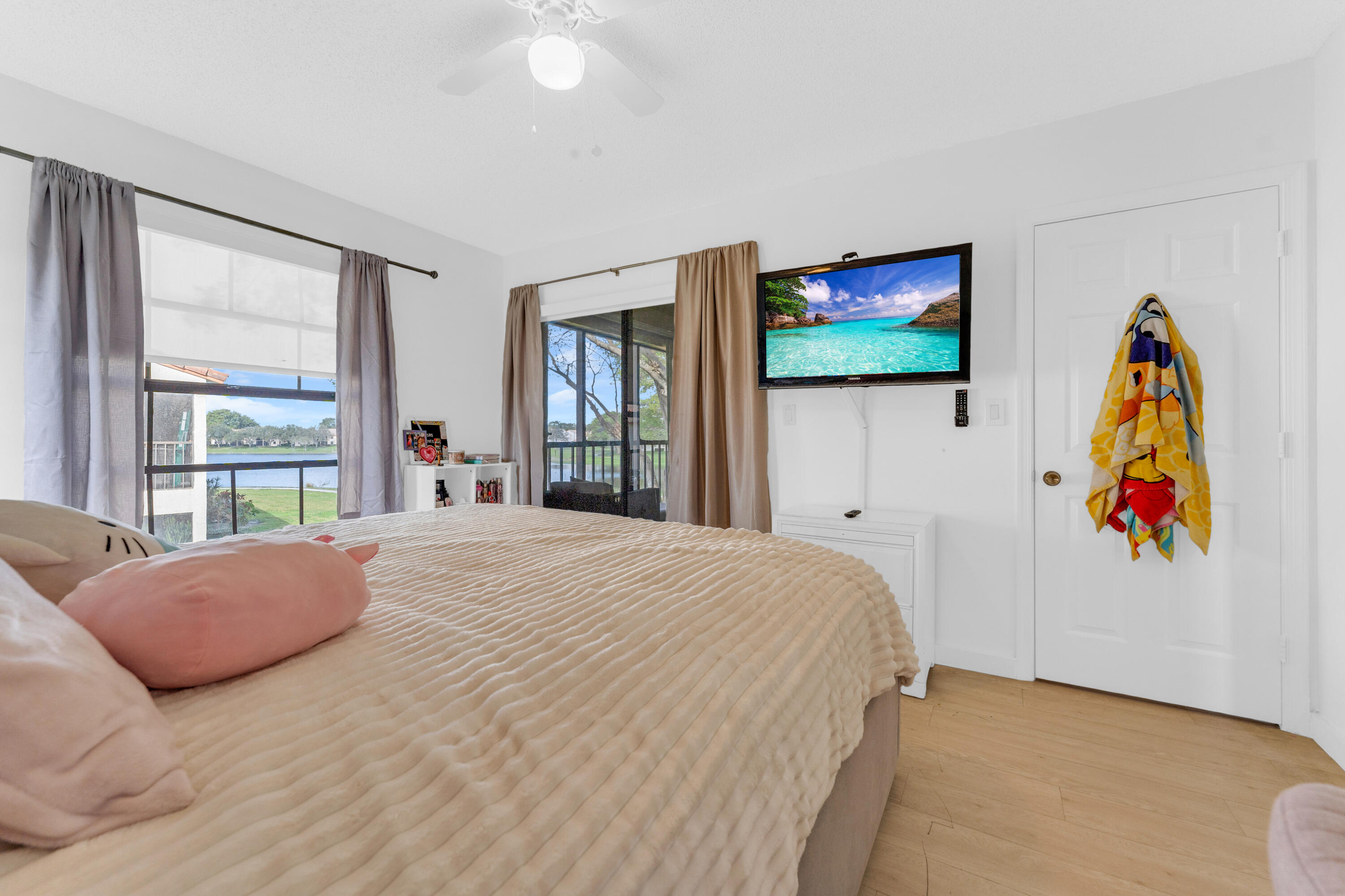 2800 Palmwood Terrace, Unit 2190 Boca Raton, FL 33431 - Photo 17 of 42 a bedroom with a bed and a flat screen tv