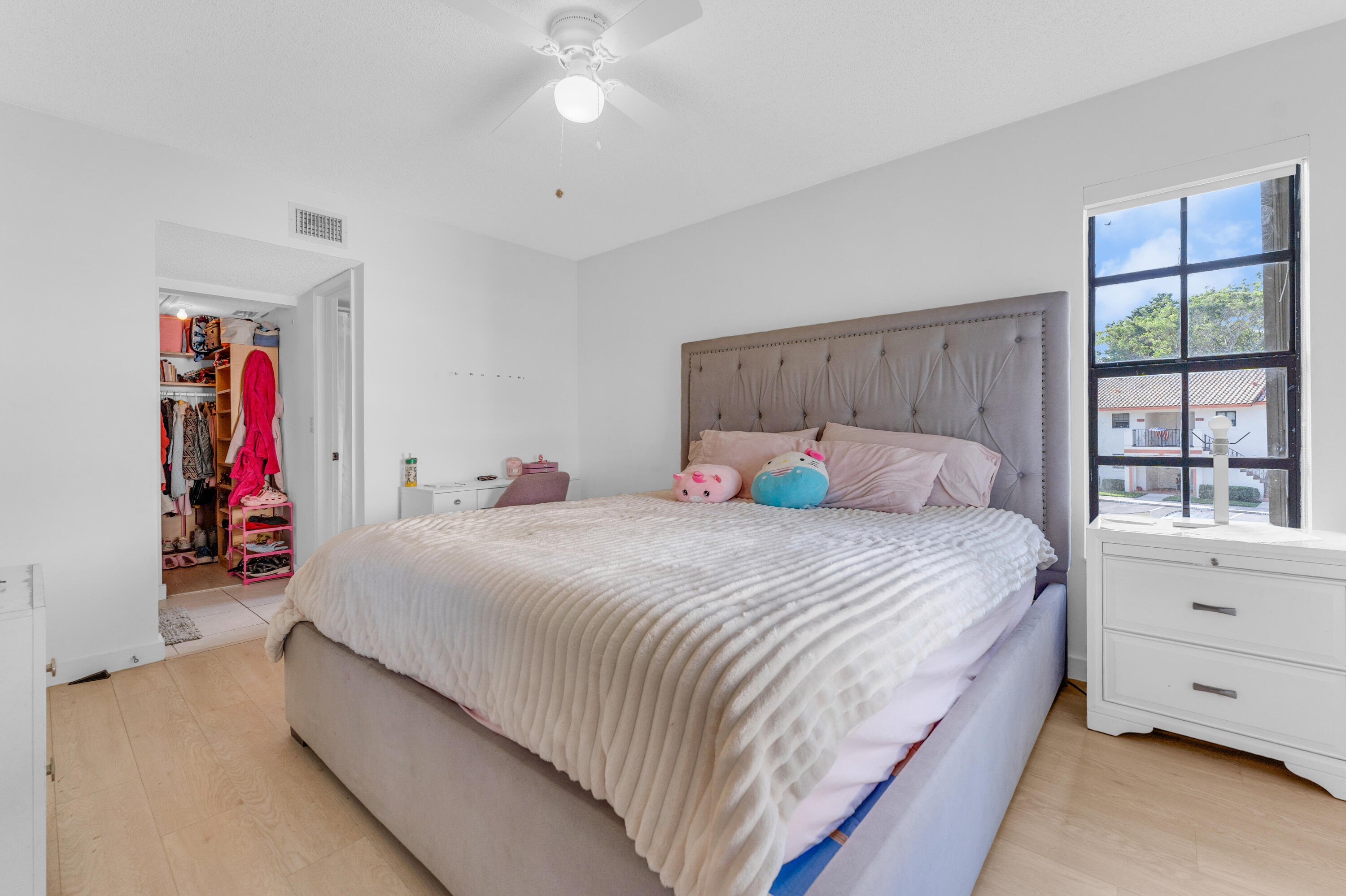 2800 Palmwood Terrace, Unit 2190 Boca Raton, FL 33431 - Photo 19 of 42 a bedroom with bed and window