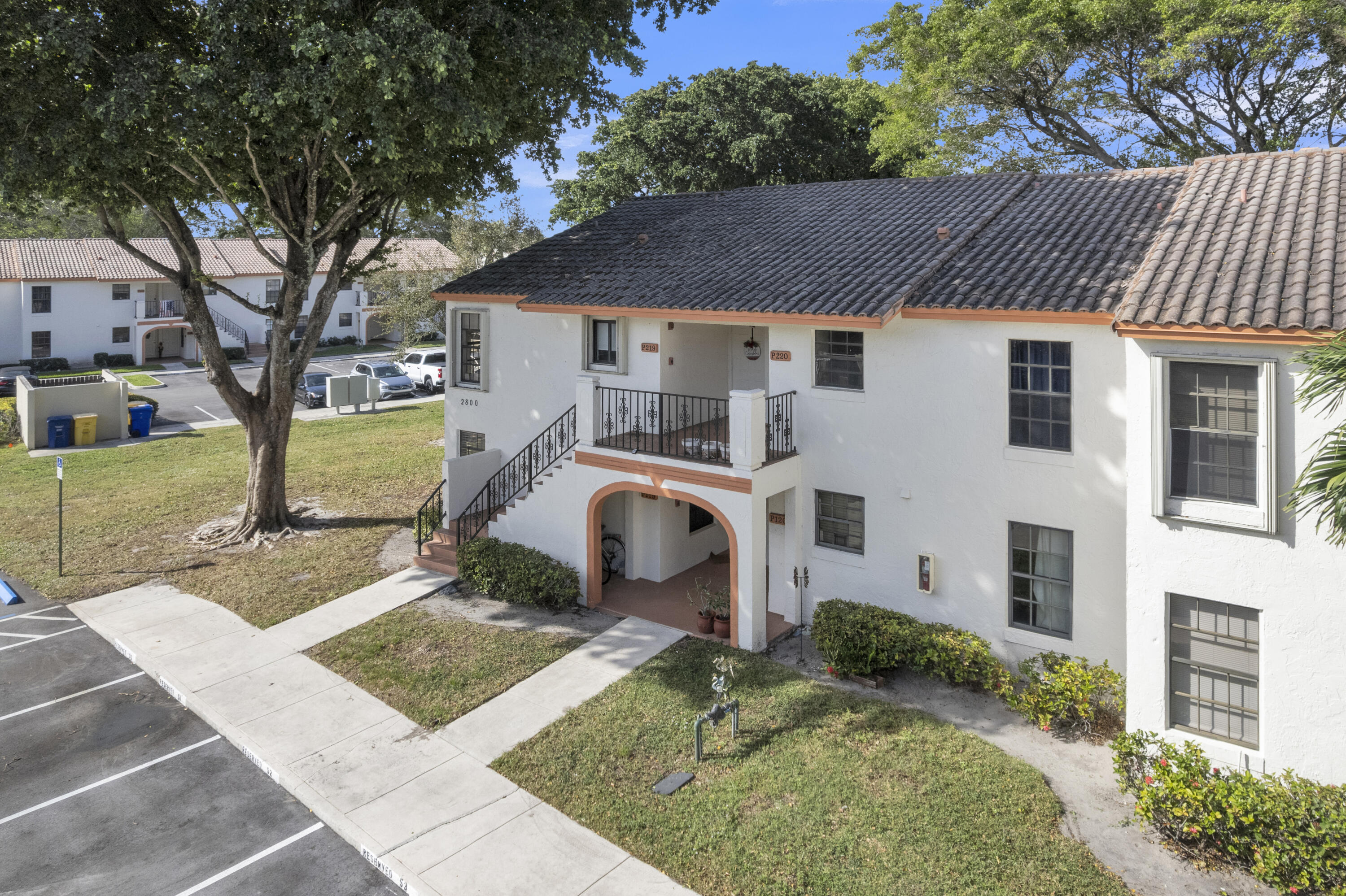 2800 Palmwood Terrace, Unit 2190 Boca Raton, FL 33431 - Photo 2 of 42 a front view of a house with a yard
