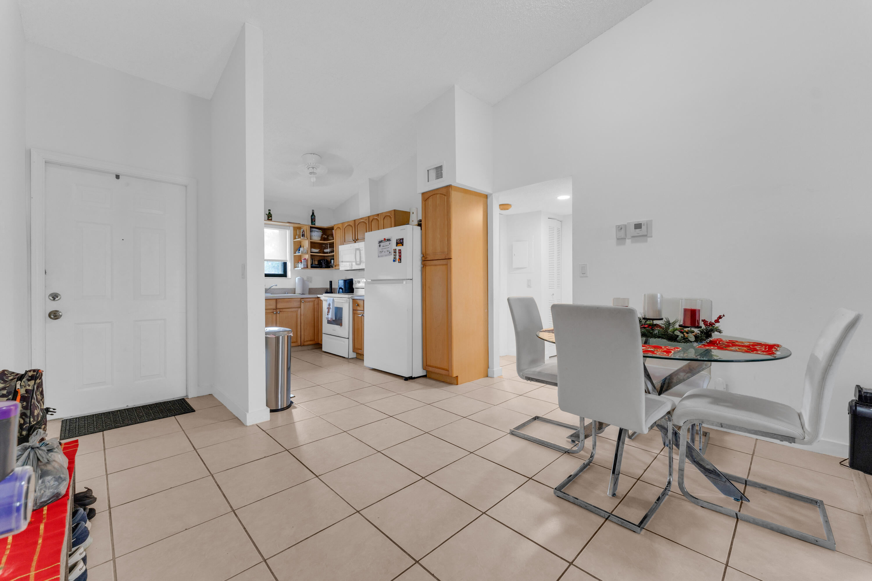2800 Palmwood Terrace, Unit 2190 Boca Raton, FL 33431 - Photo 26 of 42 a living room with furniture and a refrigerator
