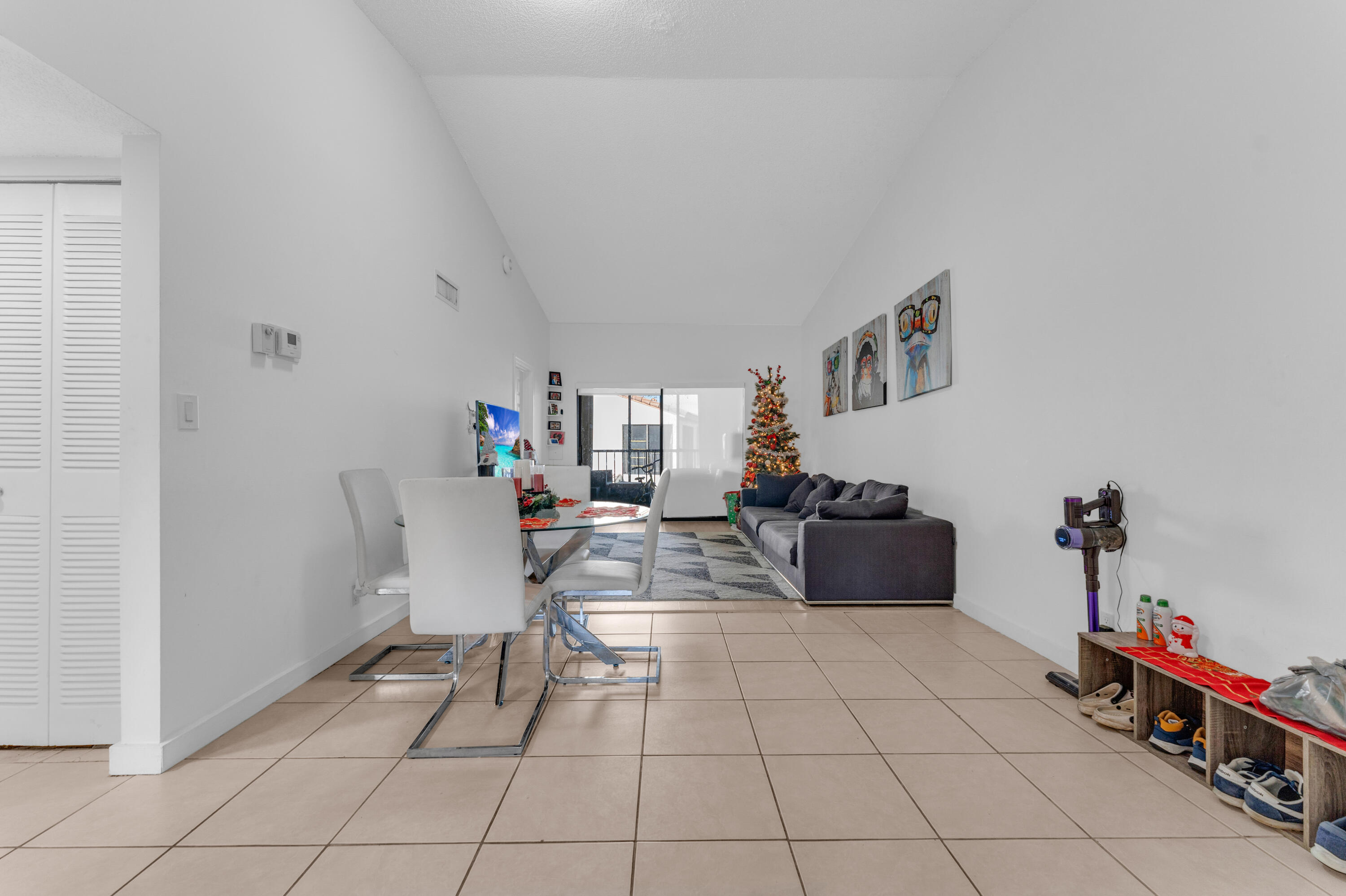 2800 Palmwood Terrace, Unit 2190 Boca Raton, FL 33431 - Photo 30 of 42 a living room with furniture and a dining table