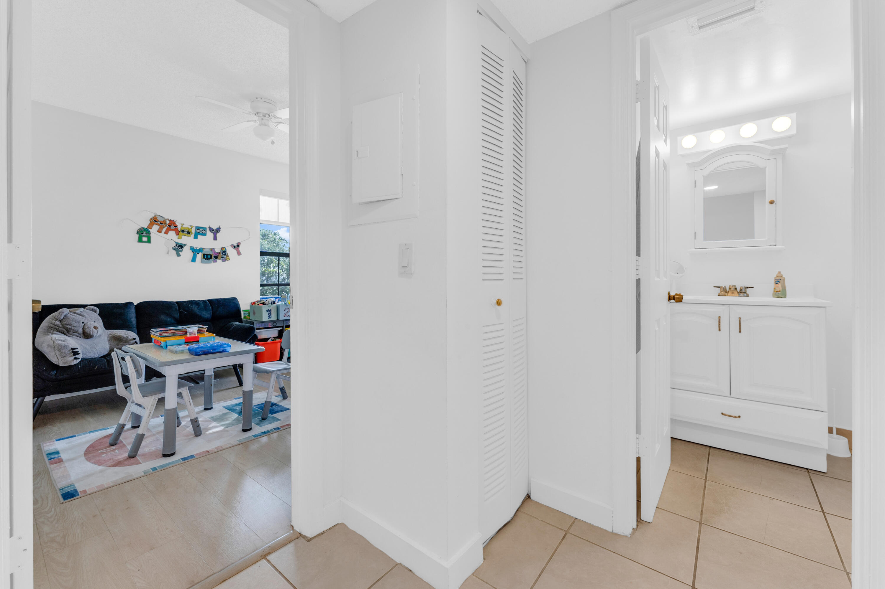 2800 Palmwood Terrace, Unit 2190 Boca Raton, FL 33431 - Photo 33 of 42 a workspace with white cabinets and wooden floor