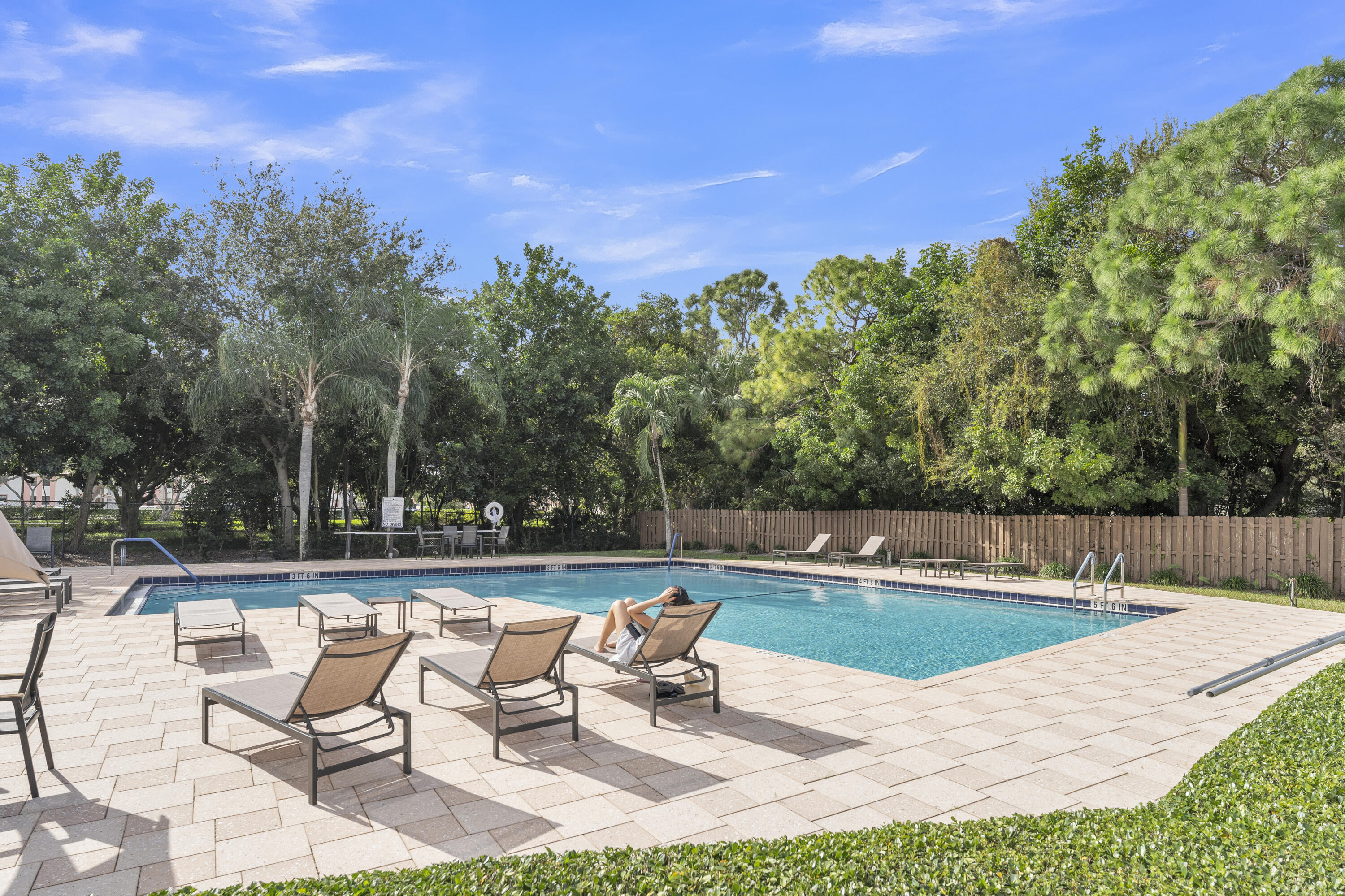 2800 Palmwood Terrace, Unit 2190 Boca Raton, FL 33431 - Photo 6 of 42 a view of swimming pool with seating space and trees in the background
