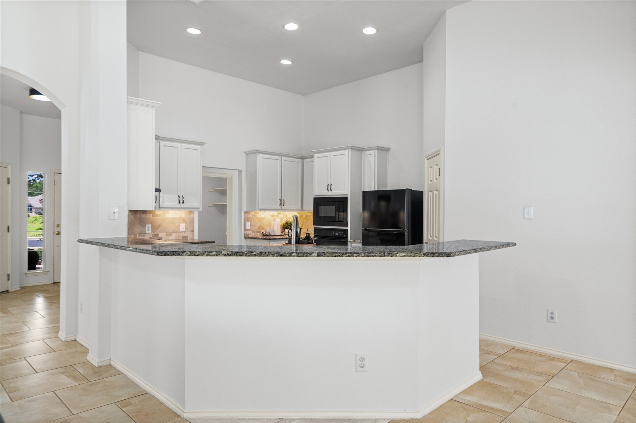 2920 Warwick Way Austin, TX 78748 - Photo 15 of 36 Granite counters, breakfast bar, and stainless steel appliances complete this well-appointed, contemporary kitchen space