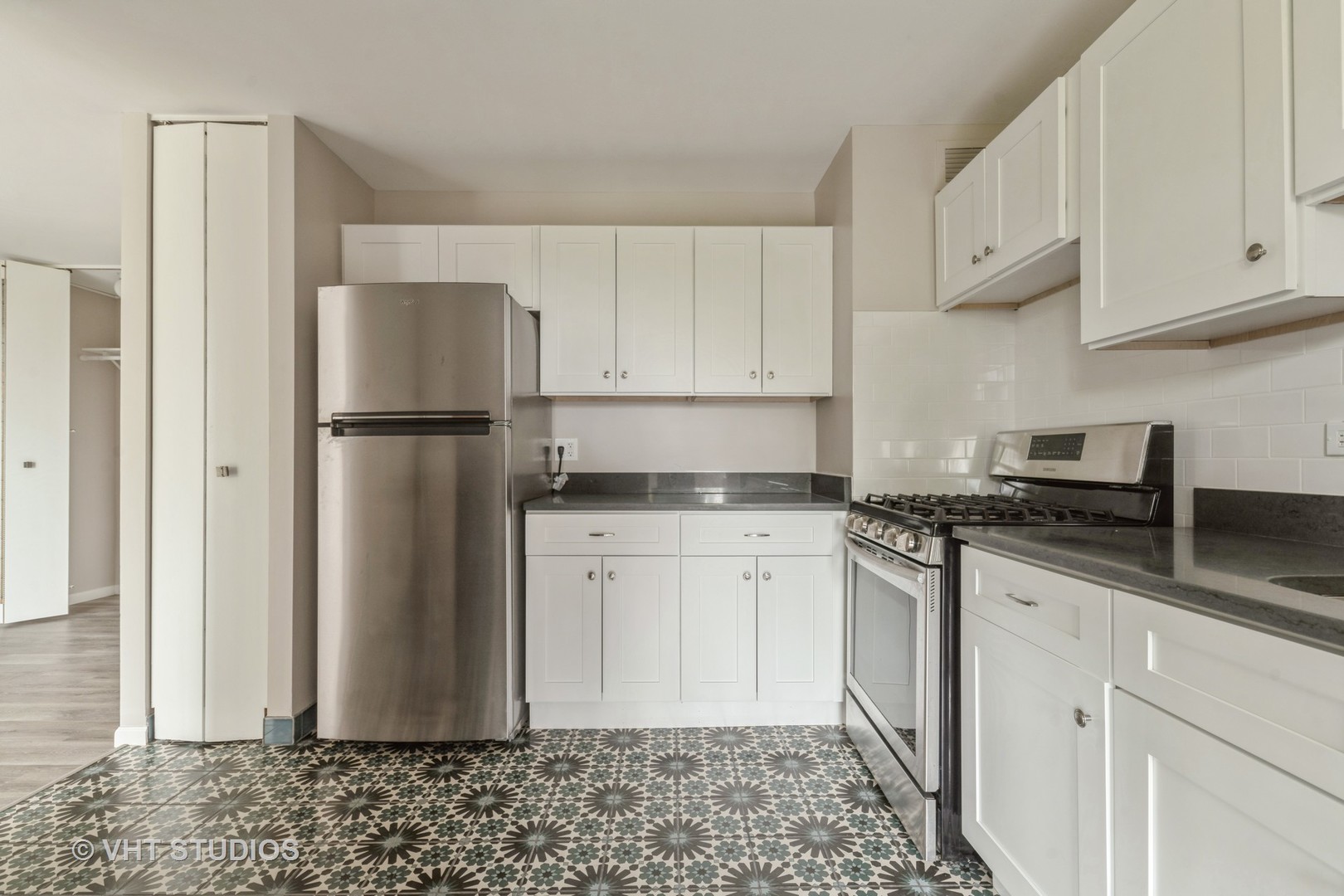 4850 South Lake Park Avenue, Unit 512 Chicago, IL 60615 - Photo 12 of 18 a kitchen with stainless steel appliances granite countertop a refrigerator a stove a sink and white cabinets