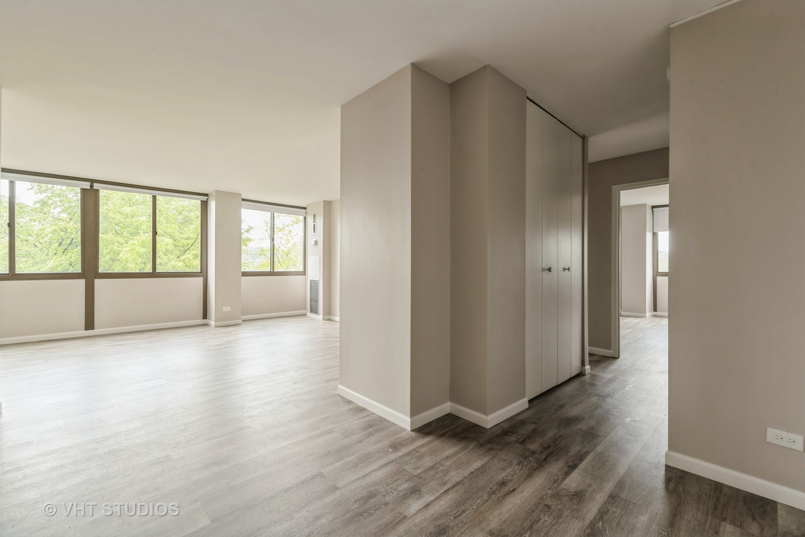 4850 South Lake Park Avenue, Unit 512 Chicago, IL 60615 - Photo 2 of 18 an empty room with wooden floor and windows