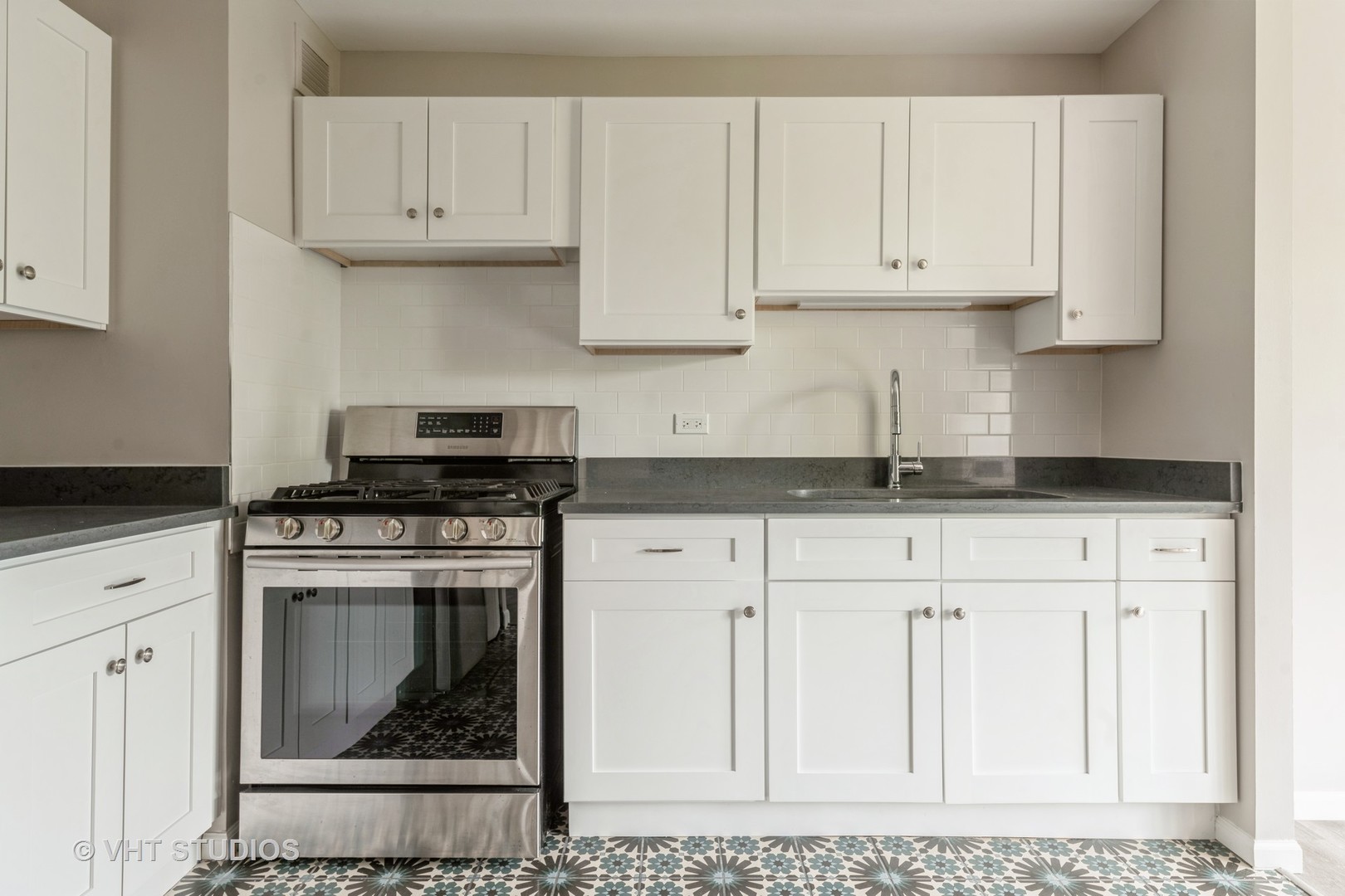 4850 South Lake Park Avenue, Unit 512 Chicago, IL 60615 - Photo 9 of 18 a kitchen with stainless steel appliances granite countertop a stove a white cabinet and a granite counter tops