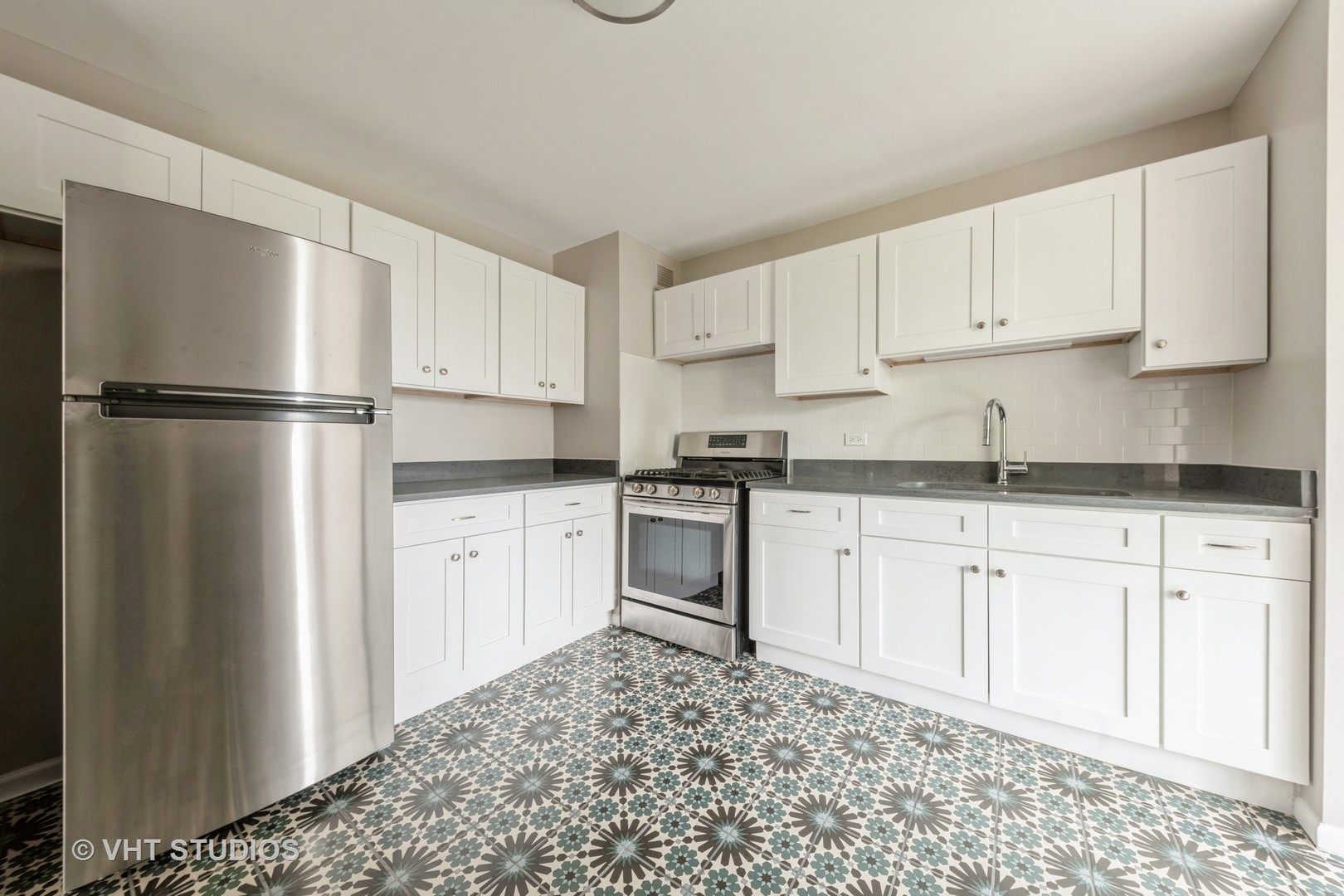 4850 South Lake Park Avenue, Unit 512 Chicago, IL 60615 - Photo 10 of 18 a kitchen with granite countertop white cabinets and refrigerator