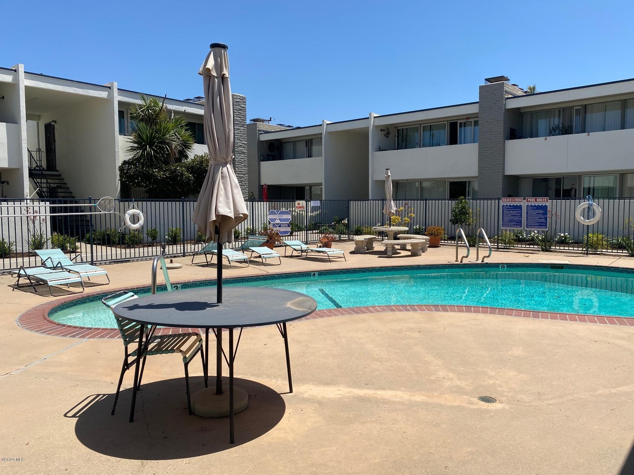 1367 Edgewood Way, Unit 67 Oxnard, CA 93030 - Photo 12 of 13 a swimming pool with outdoor seating and yard