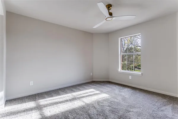 a view of room with a ceiling fan and window