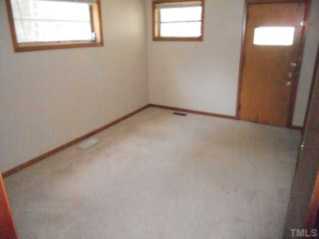 8515 Ten-Ten Road Raleigh, NC 27603 - Photo 4 of 8 an empty room with a window