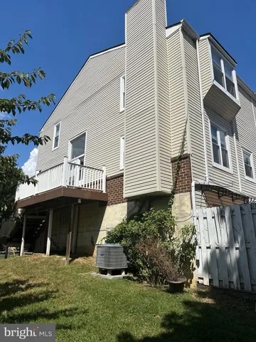 a view of a house with wooden fence