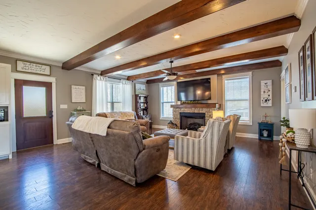 a living room with fireplace furniture and a wooden floor