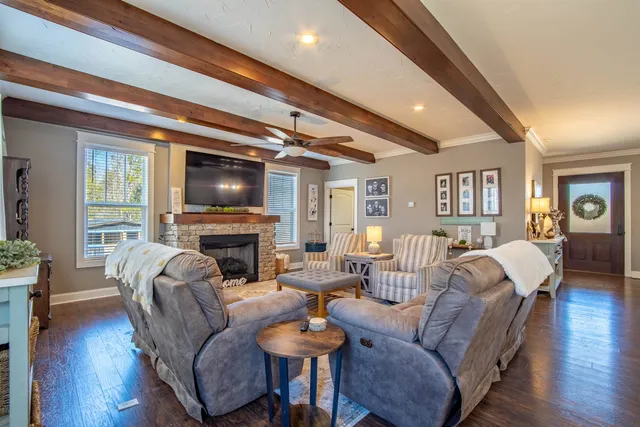 a living room with fireplace furniture and a flat screen tv