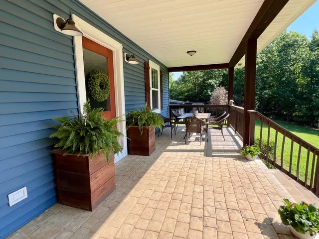 a porch with seating space and hardwood floor