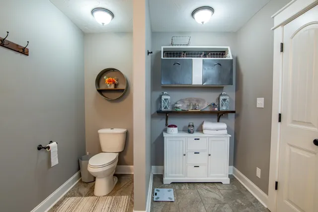 a kitchen with a refrigerator a stove a washer dryer and a dining table