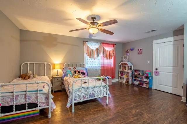 a bedroom with furniture and a wooden floor