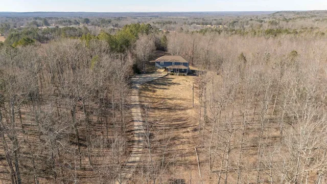 a view of a house with backyard porch and sitting area