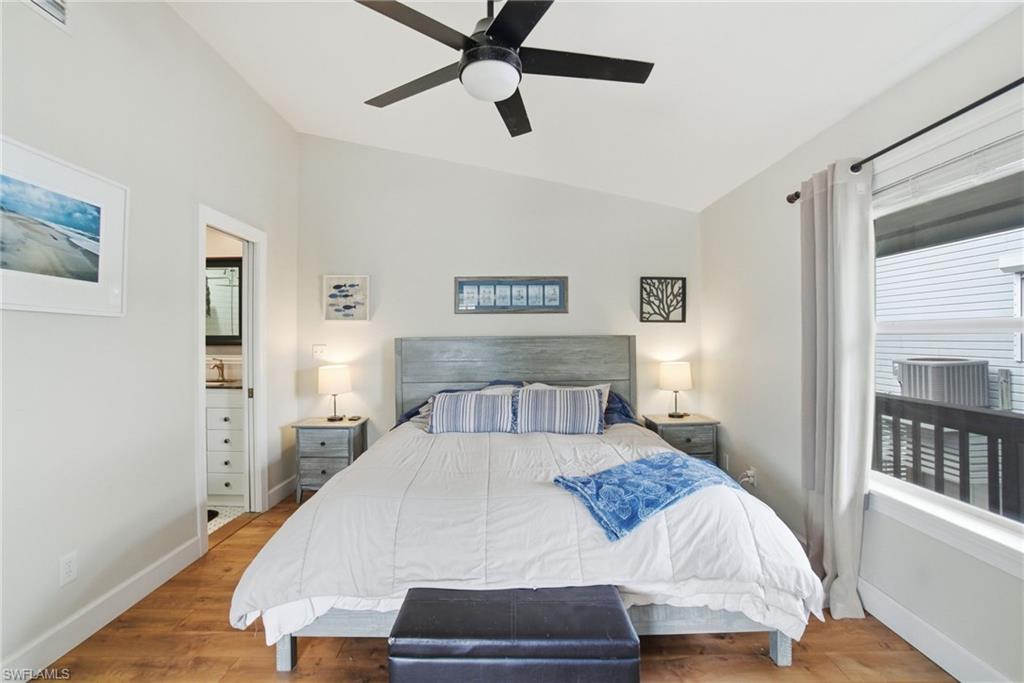 1286 Venetian Way Naples, FL 34110 - Photo 11 of 46 a bedroom with a bed and a table