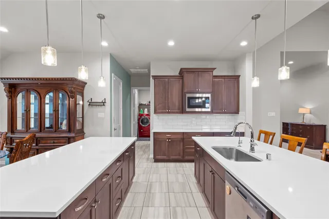 a large kitchen with kitchen island a sink stove and refrigerator