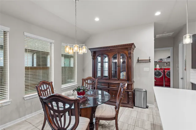 a dining room with furniture and window
