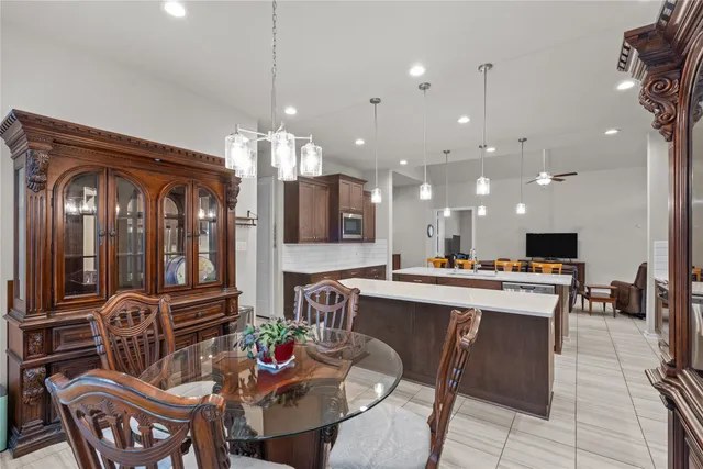 a view of a dining room and livingroom with furniture wooden floor a chandelier