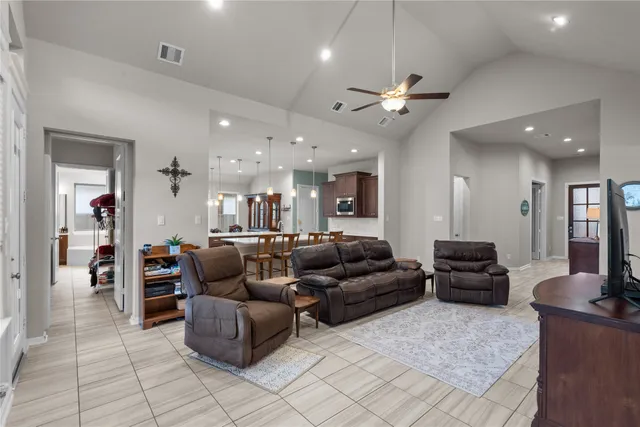 a living room with furniture and a chandelier