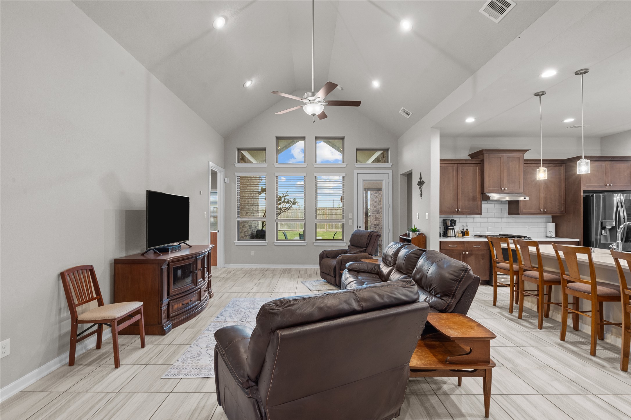 5814 Lavaca Lane Manvel, TX 77578 - Photo 22 of 37 a living room with furniture a ceiling fan and a flat screen tv