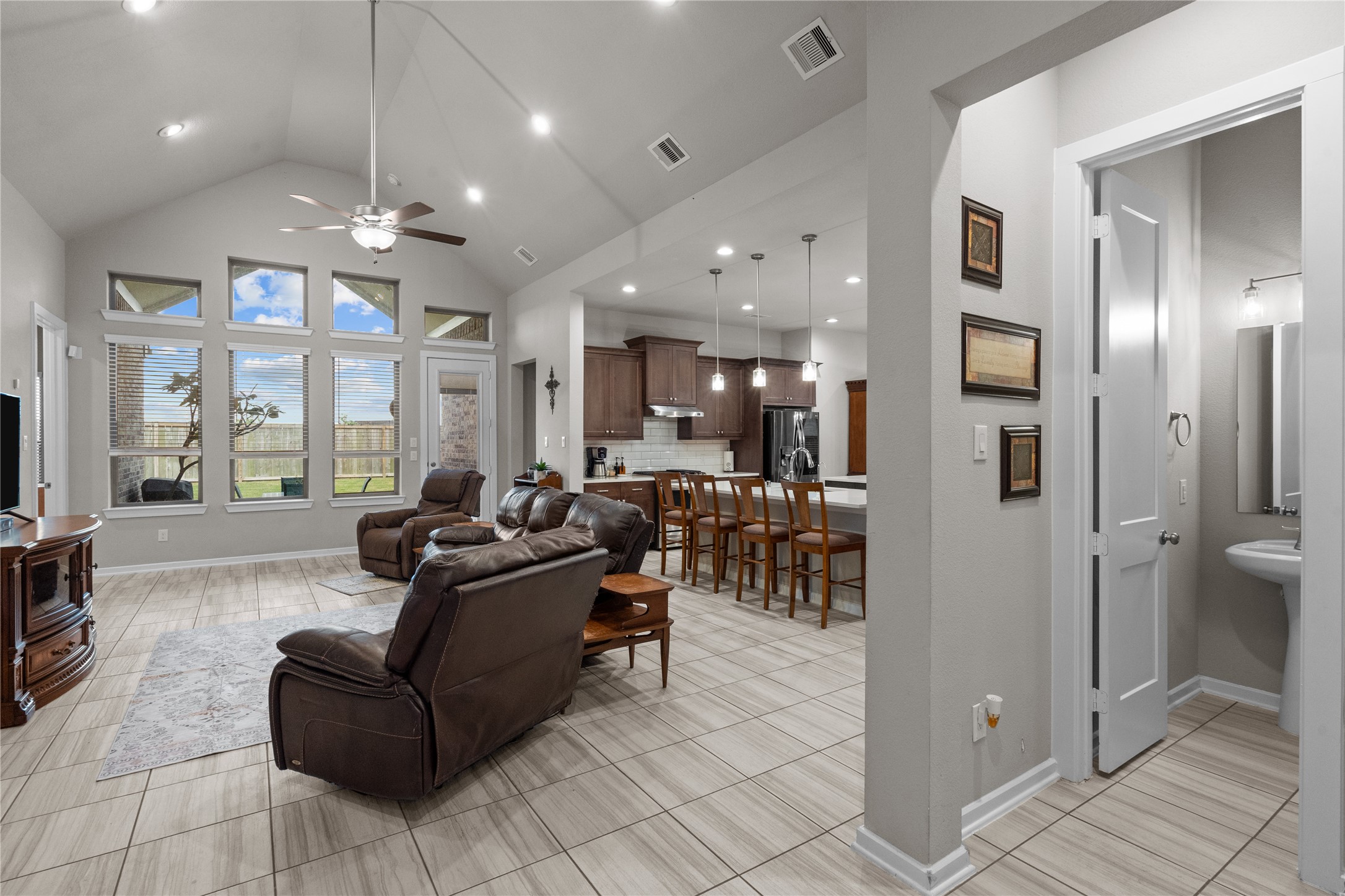 5814 Lavaca Lane Manvel, TX 77578 - Photo 23 of 37 a living room with furniture a large window and stainless steel appliances