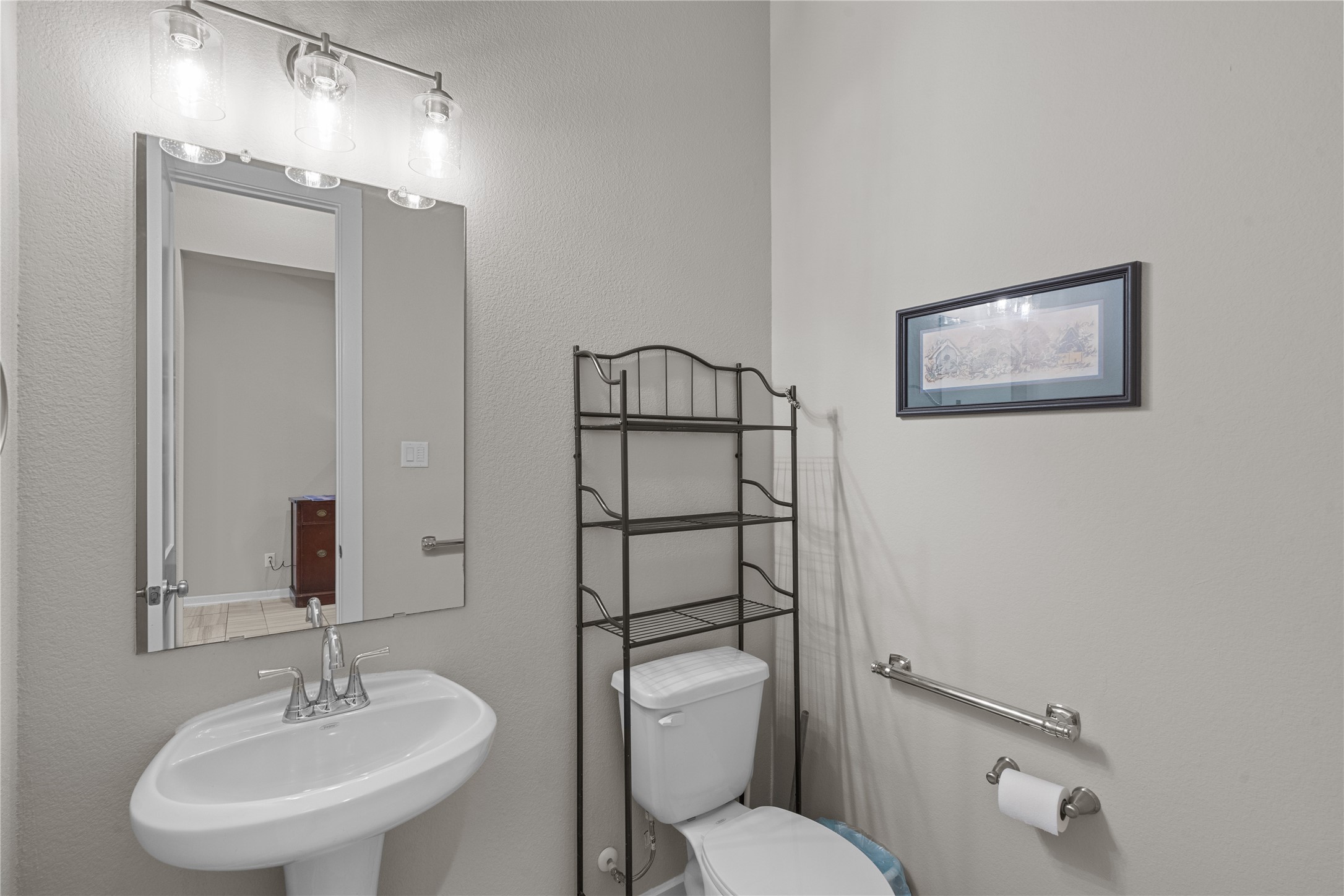 5814 Lavaca Lane Manvel, TX 77578 - Photo 24 of 37 a bathroom with a toilet sink and mirror