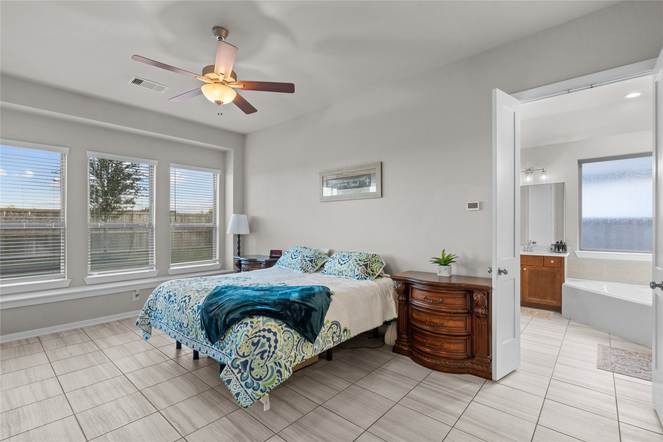 5814 Lavaca Lane Manvel, TX 77578 - Photo 26 of 37 a spacious bedroom with a bed and a chandelier