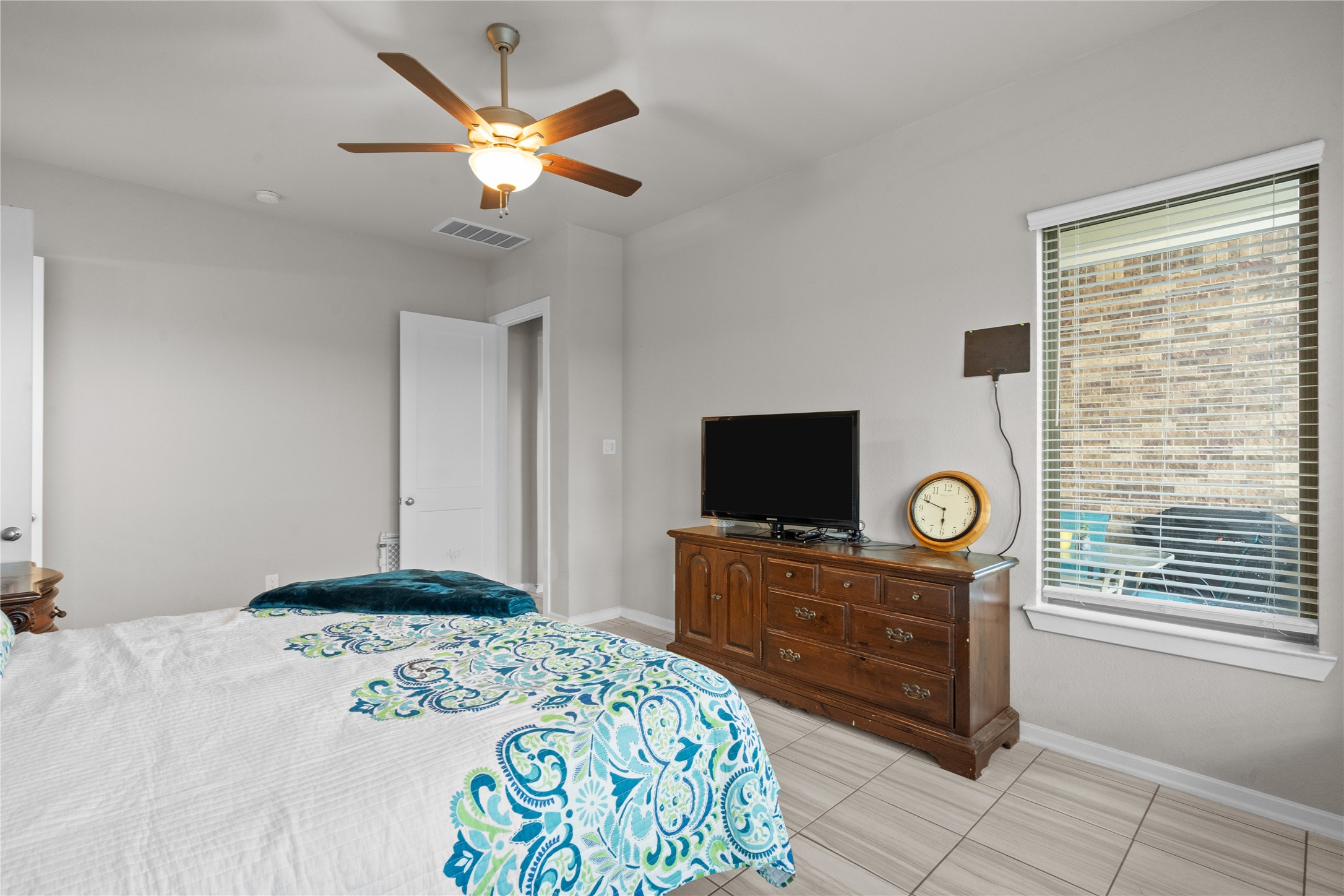 5814 Lavaca Lane Manvel, TX 77578 - Photo 27 of 37 a bedroom with a bed and a flat screen tv