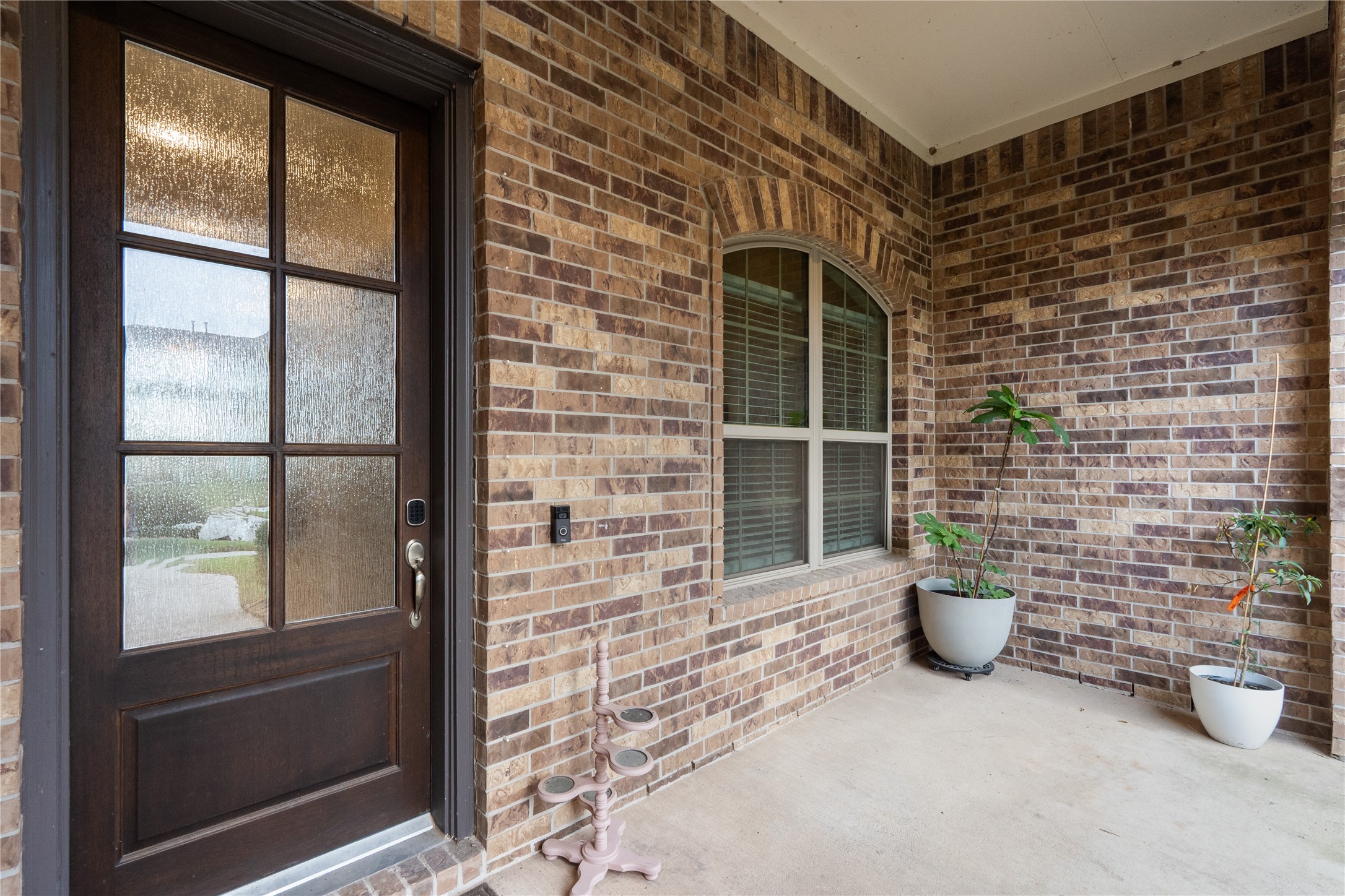 5814 Lavaca Lane Manvel, TX 77578 - Photo 3 of 37 a view of a brick house with potted plants in front of door