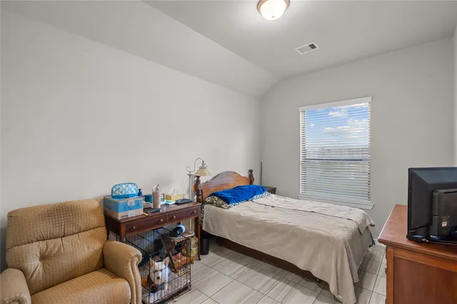 a bedroom with a bed and a couch