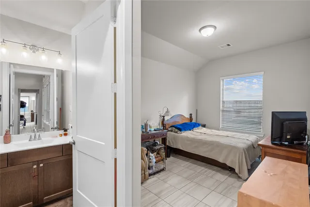 a bedroom with a bed and a television