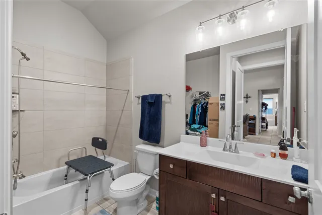 a bathroom with a double vanity sink toilet mirror and shower