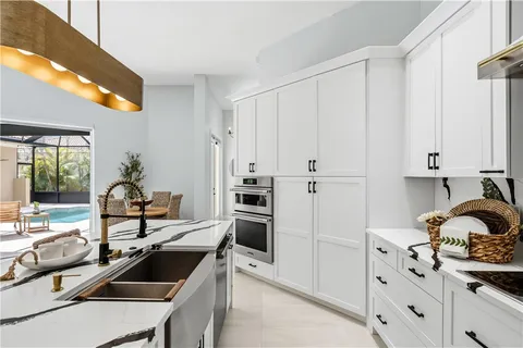 a kitchen with a sink appliances and cabinets