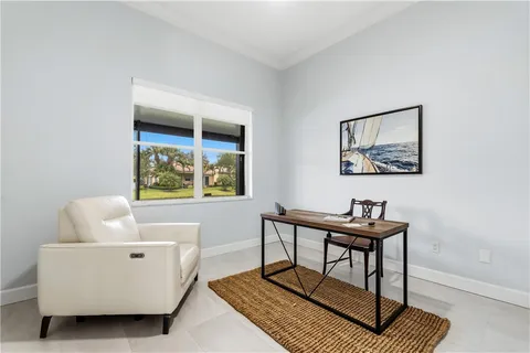 a living room with furniture a window and a table