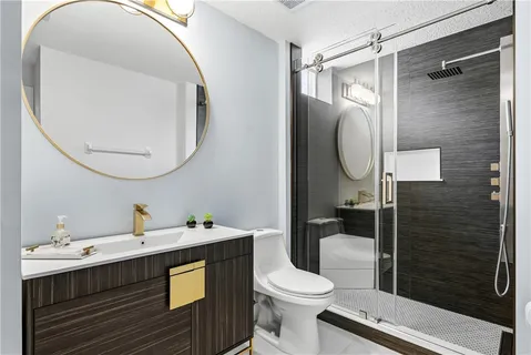 a bathroom with a sink a toilet and shower